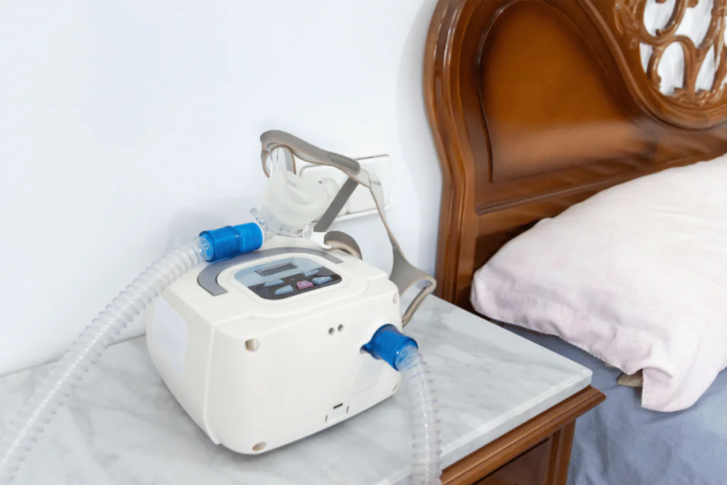 A CPAP machine sitting on a nightstand