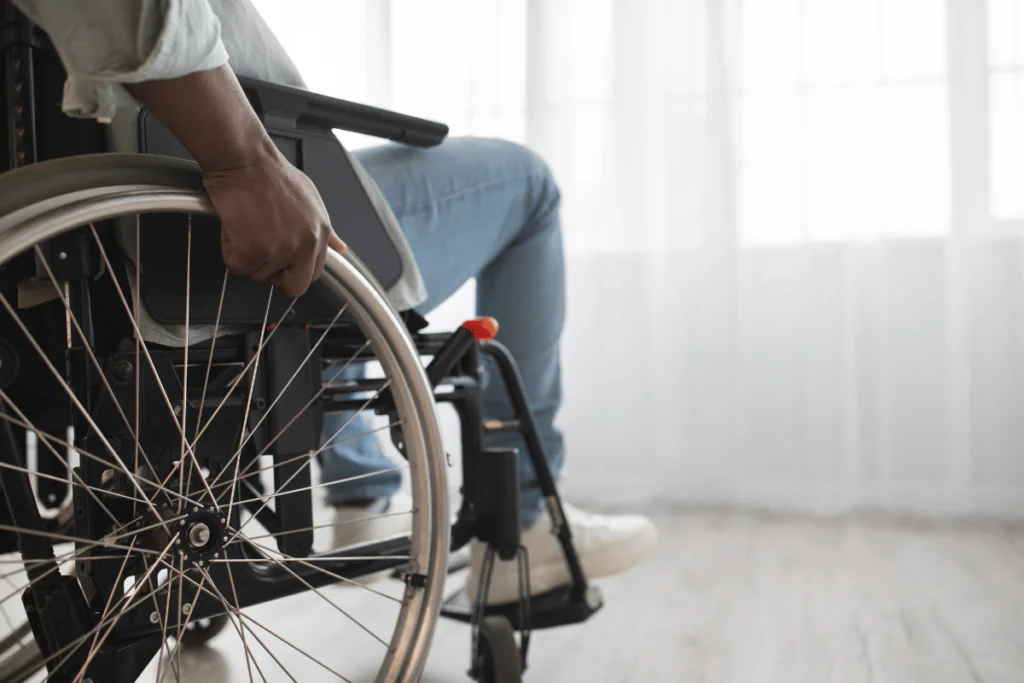 A young man using a wheelchair at home